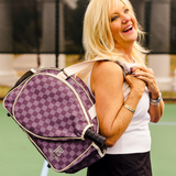 Woman carrying a fashionable women's pickleball bag with stylish brown checkered design.